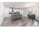 An open kitchen and dining area with white cabinets and a gray island at 5489 Nantahala Ln, Lady Lake, FL 32159