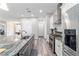 This kitchen features modern stainless appliances, granite counters, and flows seamlessly to the living area at 5489 Nantahala Ln, Lady Lake, FL 32159
