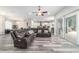 Open-concept living room with gray wood floors and a large sectional sofa at 5489 Nantahala Ln, Lady Lake, FL 32159