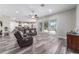 Open-concept living room with recessed lighting, wood floors and a large reclining leather sofa at 5489 Nantahala Ln, Lady Lake, FL 32159