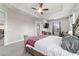 Spacious main bedroom suite with tray ceilings, ceiling fan, and outdoor access at 5489 Nantahala Ln, Lady Lake, FL 32159