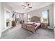 Spacious main bedroom suite with tray ceilings, ceiling fan, and outdoor access at 5489 Nantahala Ln, Lady Lake, FL 32159