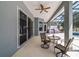Covered patio with a ceiling fan, outdoor seating, and access to the pool at 5489 Nantahala Ln, Lady Lake, FL 32159
