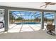 Enclosed screened pool featuring a waterfall, spa and nice backyard views at 5489 Nantahala Ln, Lady Lake, FL 32159