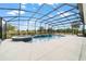 Screened-in pool with a spillover spa and lush green backyard views at 5489 Nantahala Ln, Lady Lake, FL 32159