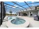 Pool and Spa with an enclosure, along with outdoor seating and barbecue at 5489 Nantahala Ln, Lady Lake, FL 32159