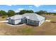 Low aerial view showing the rear of the home and surrounding acreage at 5489 Nantahala Ln, Lady Lake, FL 32159
