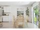 Bright dining area features neutral decor, light wood table, and access to outdoor living space at 615 Marion Oaks Blvd, Ocala, FL 34473