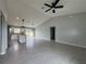 Open-concept living space featuring tile flooring and a modern kitchen with island and stainless steel appliances at 6178 Sw 207Th Ct, Dunnellon, FL 34431
