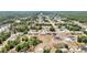 Aerial shot of a tranquil neighborhood with various single-Gathering homes, interspersed with greenery and curving roads at 6570 Sw 129Th Loop, Ocala, FL 34473