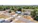 This aerial view showcases homes in a tranquil neighborhood near lush trees, creating a serene residential environment at 6570 Sw 129Th Loop, Ocala, FL 34473