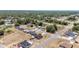 An aerial view of a quiet neighborhood, featuring tidy homes with green trees and well-maintained roads at 6570 Sw 129Th Loop, Ocala, FL 34473