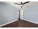 Bright bedroom with a modern ceiling fan, wood-look flooring, and neutral-colored walls at 6570 Sw 129Th Loop, Ocala, FL 34473