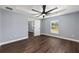 Light-filled bedroom featuring a large window, wood-look flooring, and ceiling fan at 6570 Sw 129Th Loop, Ocala, FL 34473