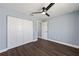 Bedroom with double closet doors and modern ceiling fan at 6570 Sw 129Th Loop, Ocala, FL 34473