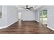 Spacious bedroom featuring hardwood style floors, fan, tray ceiling and sliding glass doors at 6570 Sw 129Th Loop, Ocala, FL 34473