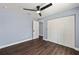 Inviting bedroom featuring a ceiling fan, closet, and wood-look flooring, offering ample space at 6570 Sw 129Th Loop, Ocala, FL 34473
