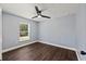 Well-lit bedroom with wood-look flooring and a modern ceiling fan, showcasing comfort and style at 6570 Sw 129Th Loop, Ocala, FL 34473