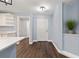 Front door entry featuring hardwood style floors and a plant resting in an inset shelf at 6570 Sw 129Th Loop, Ocala, FL 34473