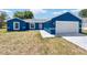 Charming blue single-story home with a two-car garage and well-lit front entrance at 6570 Sw 129Th Loop, Ocala, FL 34473
