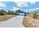 Charming blue single-story home with a two-car garage and long driveway at 6570 Sw 129Th Loop, Ocala, FL 34473