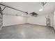 Spacious garage with sealed concrete floor, white walls, and an installed water heater at 6570 Sw 129Th Loop, Ocala, FL 34473