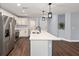Spacious kitchen featuring a large island, stainless steel appliances and hardwood floors at 6570 Sw 129Th Loop, Ocala, FL 34473