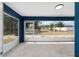 Screened lanai offering outdoor views and natural light with painted walls and concrete flooring at 6570 Sw 129Th Loop, Ocala, FL 34473