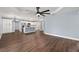 Bright living room with kitchen and island, hardwood floors and modern ceiling fan at 6570 Sw 129Th Loop, Ocala, FL 34473
