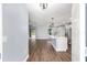 Bright living room featuring an island with pendant lights and hardwood style floors at 6570 Sw 129Th Loop, Ocala, FL 34473