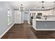 Living room view showcases white cabinets, stainless steel appliances, and island at 6570 Sw 129Th Loop, Ocala, FL 34473