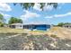 Rear view of a blue single-story home featuring a screened-in patio at 6570 Sw 129Th Loop, Ocala, FL 34473