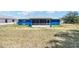 Rear view of a blue single-story home featuring a screened-in patio at 6570 Sw 129Th Loop, Ocala, FL 34473