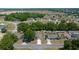 Aerial view of a residential area with lush greenery and well-maintained homes, close to commercial area at 6791 Se 100Th Pl, Belleview, FL 34420
