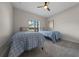 Shared bedroom with neutral paint, carpet, and natural light from window showing exterior of home at 6791 Se 100Th Pl, Belleview, FL 34420