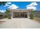Home exterior featuring a spacious garage, manicured landscaping, and a well-maintained lawn at 6791 Se 100Th Pl, Belleview, FL 34420