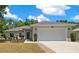 Charming single-story home with a well-manicured lawn, two-car garage, and inviting front entrance at 6791 Se 100Th Pl, Belleview, FL 34420