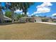 Single-story home with a two-car garage, well-maintained lawn, and inviting entrance amidst lush trees at 6791 Se 100Th Pl, Belleview, FL 34420