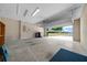 Spacious, clean garage with open door showing view of the home's exterior at 6791 Se 100Th Pl, Belleview, FL 34420