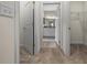 A hallway showcases an open doorway to a bathroom and another to a walk-in closet at 6791 Se 100Th Pl, Belleview, FL 34420