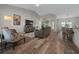 Open-concept living room with wood floors, vaulted ceilings, and modern furniture perfect for relaxation at 6791 Se 100Th Pl, Belleview, FL 34420