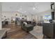 Open living area with wood floors, an airy layout, and an adjacent modern kitchen creating a seamless flow at 6791 Se 100Th Pl, Belleview, FL 34420
