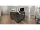 Spacious living room featuring wood flooring, large windows, and comfortable seating for a welcoming atmosphere at 6791 Se 100Th Pl, Belleview, FL 34420