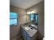 Bright bathroom with a large window, granite counters, and updated vanity at 7488 Sw 204Th Ave, Dunnellon, FL 34431
