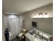 Bright bathroom with granite countertop vanity and a tub shower, offering a serene and functional space at 7488 Sw 204Th Ave, Dunnellon, FL 34431