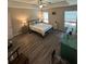 Large bedroom with wood-look floors, ceiling fan, and bright natural light at 7488 Sw 204Th Ave, Dunnellon, FL 34431