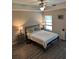 This cozy bedroom features wood-look floors, a ceiling fan, and lots of natural light at 7488 Sw 204Th Ave, Dunnellon, FL 34431