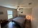 Comfortable bedroom with ceiling fan, natural light, and modern decor, creating a serene atmosphere at 7488 Sw 204Th Ave, Dunnellon, FL 34431