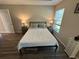 This cozy bedroom features wood-look floors, a ceiling fan, and lots of natural light at 7488 Sw 204Th Ave, Dunnellon, FL 34431