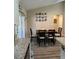Eat-in kitchen with natural light and backyard view, dining table seats four, and picture collage at 7488 Sw 204Th Ave, Dunnellon, FL 34431